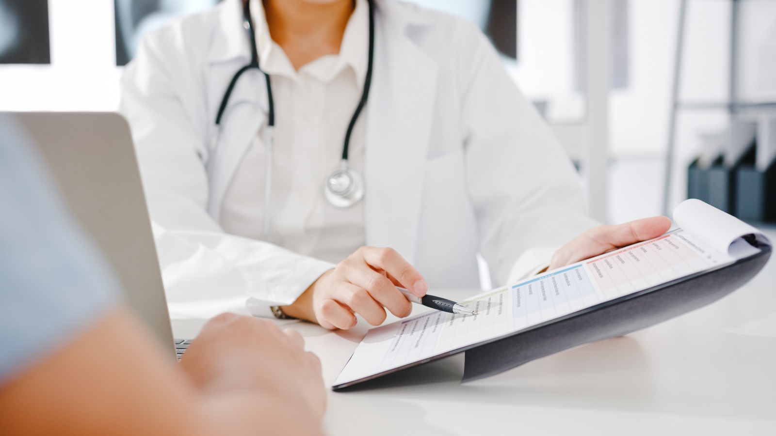 Doctor sharing screening results with a member