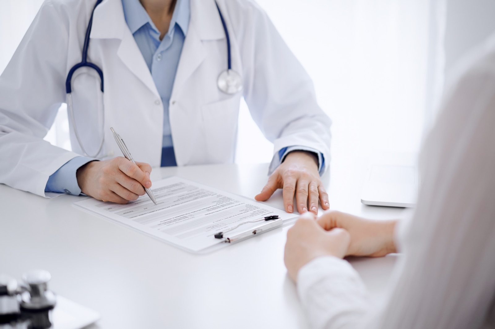 Doctor and member discussing a health-screening plan at a clinic